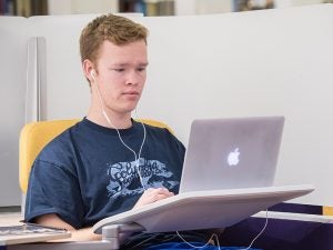 A student works on his laptop